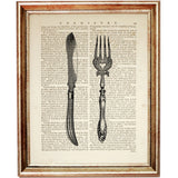 Curved vintage table knife paired with an ornate fork on an antique dictionary page, black-and-white kitchen wall art
