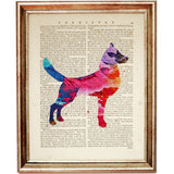 Colourful abstract illustration of a standing dog with pointed ears and a raised tail, featuring pink, purple, blue and orange tones on a dictionary page.